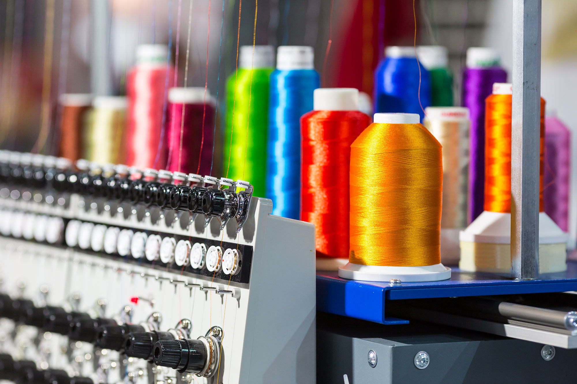 photodune-cpCeN2Iz-spools-of-color-threads-closeup-spinning-machine-l